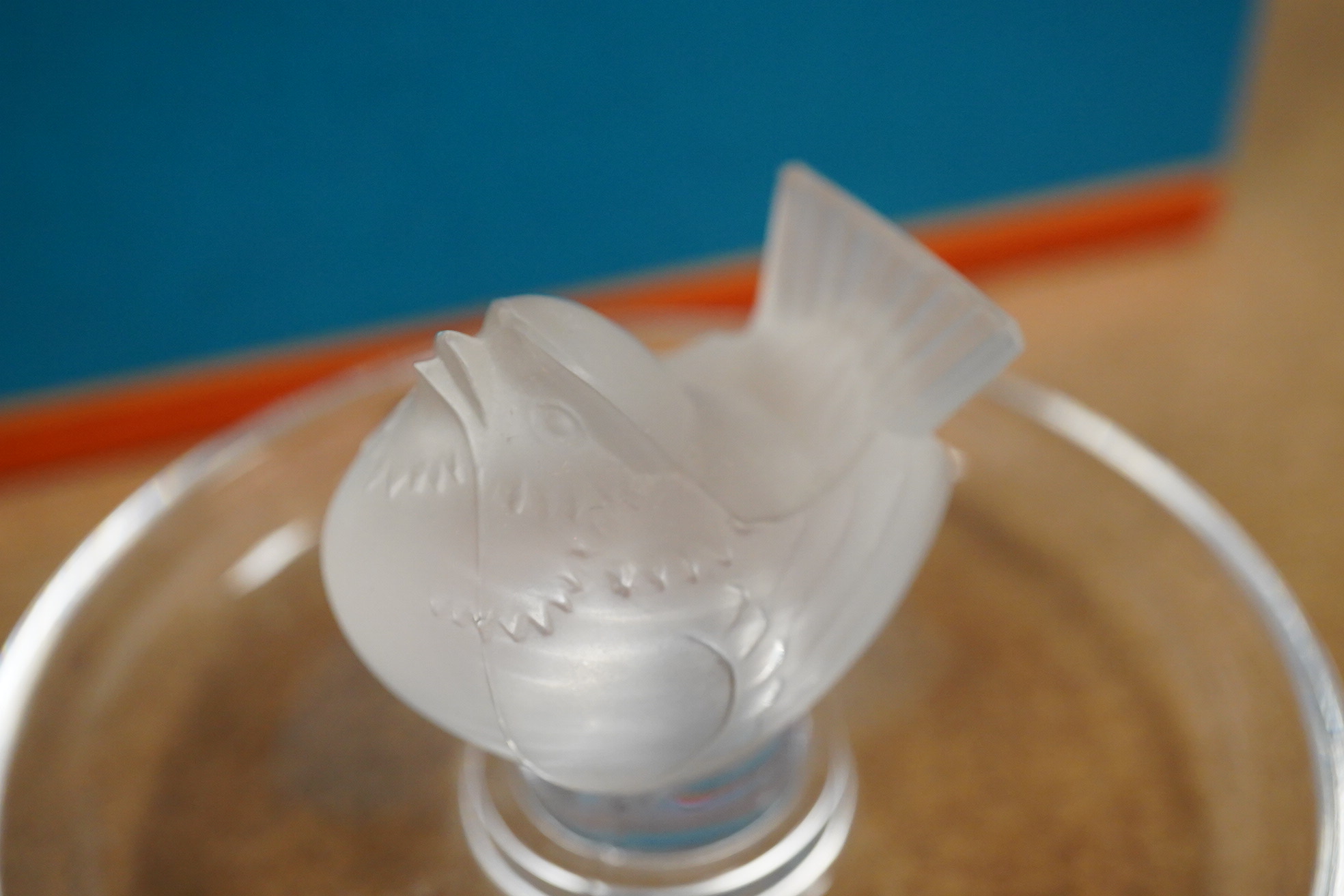 A Lalique bird pin dish and a Lalique perfume trio, Les Introuvables, in original box, pin dish 9cm